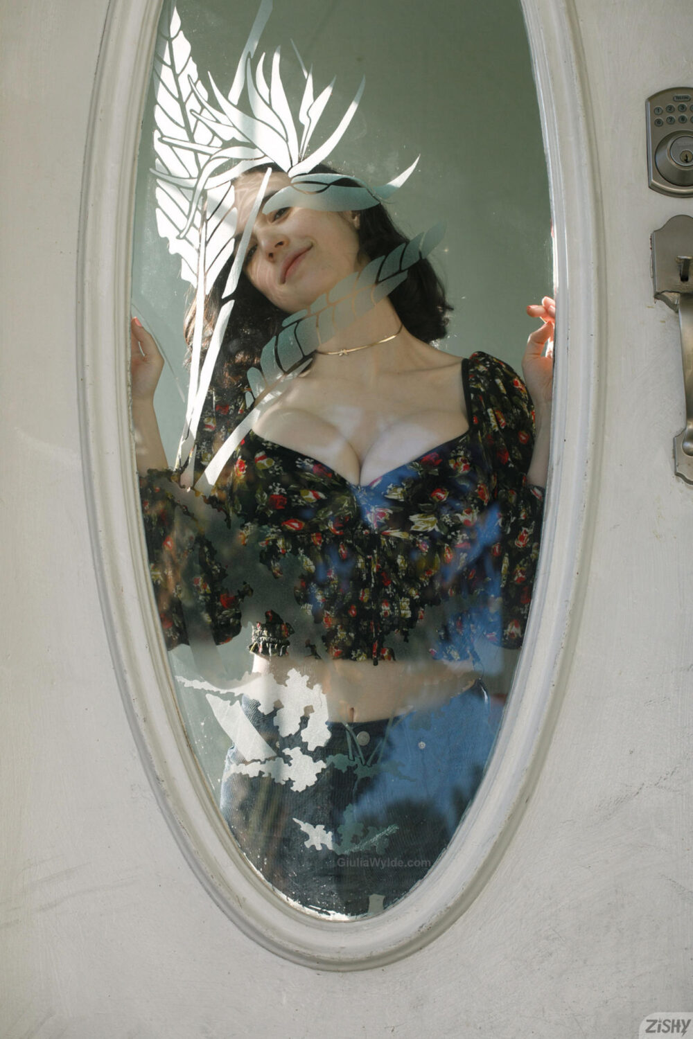 Busty model pressing her boobs on glass